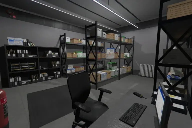 A tidy, well-lit storage room featuring shelves filled with organized boxes and folders. A desk with a computer, keyboard, and chair sits in the foreground.