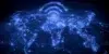 A glowing blue map of the world shows connected lines and Wi-Fi symbols above continents, symbolizing global communication and connectivity.