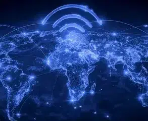 A glowing blue map of the world shows connected lines and Wi-Fi symbols above continents, symbolizing global communication and connectivity.