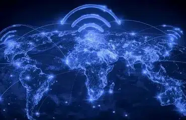 A glowing blue map of the world shows connected lines and Wi-Fi symbols above continents, symbolizing global communication and connectivity.