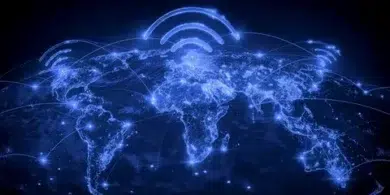 A glowing blue map of the world shows connected lines and Wi-Fi symbols above continents, symbolizing global communication and connectivity.