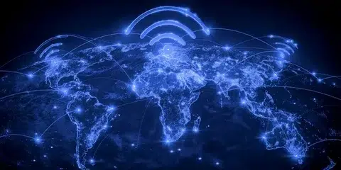 A glowing blue map of the world shows connected lines and Wi-Fi symbols above continents, symbolizing global communication and connectivity.