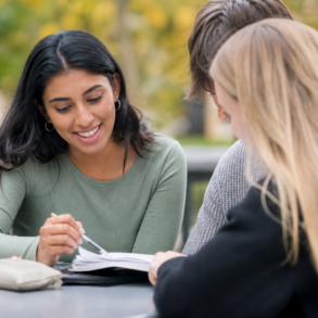 Peer Academic Leader helping college students with academic planning and study support on campus