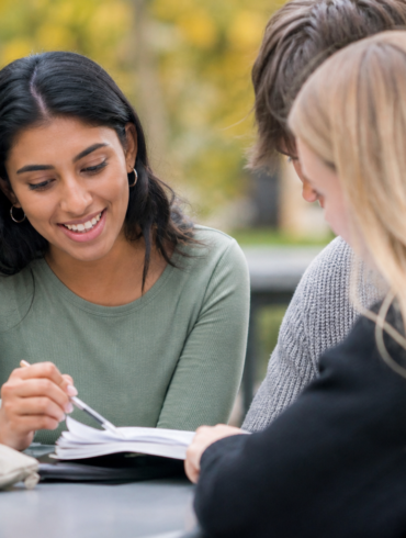 Peer Academic Leader helping college students with academic planning and study support on campus