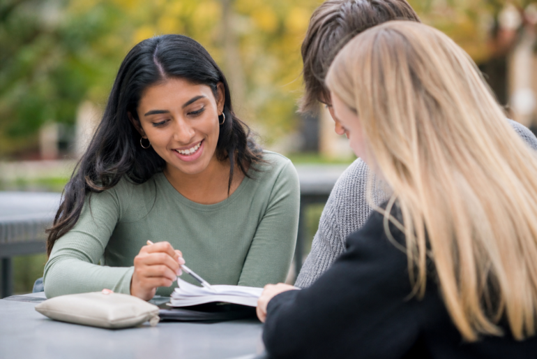 Peer Academic Leader helping college students with academic planning and study support on campus
