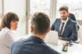 Skilled Divorce Lawyer consulting a couple in a professional office setting, discussing legal matters and relationship concerns