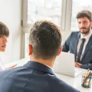 Skilled Divorce Lawyer consulting a couple in a professional office setting, discussing legal matters and relationship concerns