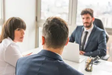 Skilled Divorce Lawyer consulting a couple in a professional office setting, discussing legal matters and relationship concerns