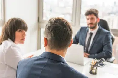 Skilled Divorce Lawyer consulting a couple in a professional office setting, discussing legal matters and relationship concerns