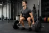 Person performing a Trap Bar Deadlift in a gym with proper form for strength, power, and safer lifting