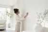 White Wallpaper in a clean modern living room with soft furniture, natural light, and subtle textured wall design.