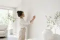 White Wallpaper in a clean modern living room with soft furniture, natural light, and subtle textured wall design.