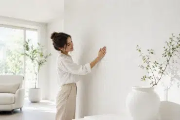 White Wallpaper in a clean modern living room with soft furniture, natural light, and subtle textured wall design.