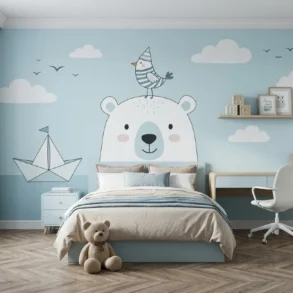 Children's room with a light blue wall featuring a cute bear mural, a bird on its head, and clouds. A cozy bed, desk, and teddy bear add warmth.