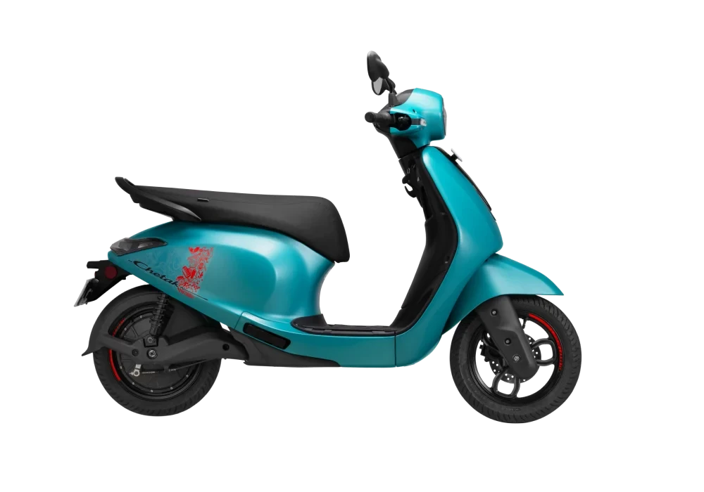 Turquoise electric scooter with a black seat and red accents on the wheels against a black background.