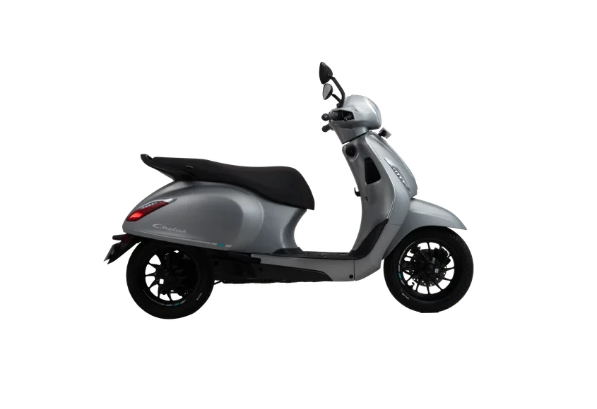 A silver electric scooter with black wheels is shown against a black background.
