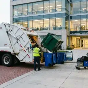 Garbage truck collecting waste outside Axis Professional Center. Two workers in safety vests manage bins, with a modern glass building in the background.