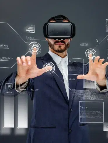 Man wearing VR headset interacts with futuristic data interfaces displaying charts and statistics.