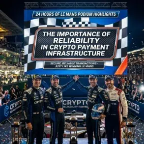 Four racing drivers stand on a podium with a crowd cheering in the background and a large screen displaying "The Importance of Reliability in Crypto Payment Infrastructure" at the 24 Hours of Le Mans.