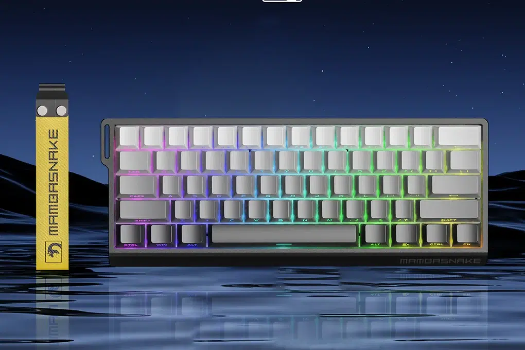 MAMBASNAKE mechanical keyboard with RGB backlighting sits on a reflective surface against a starry night sky.
