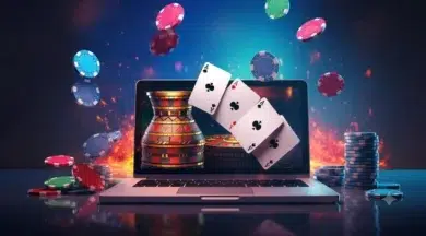 Laptop displaying casino game with poker chips and playing cards appearing to fly out from the screen.