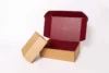 Opened brown cardboard box with a deep red interior and the word "TUSTING" printed inside the lid.