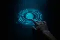A finger touches a glowing blue fingerprint scanner on a dark background.