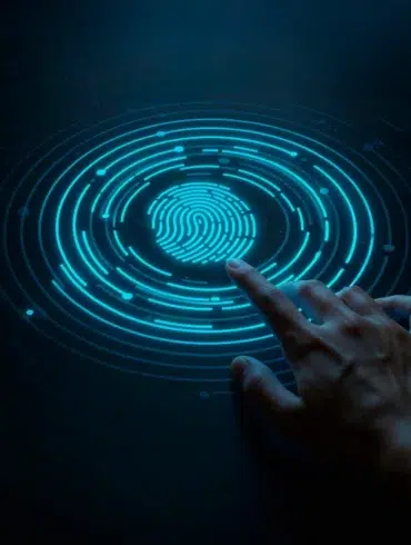 A finger touches a glowing blue fingerprint scanner on a dark background.