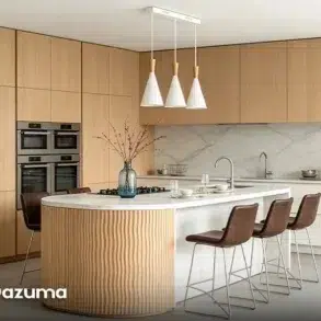 Modern kitchen with light wood cabinetry, double ovens, a marble backsplash, and a curved island with bar stools.