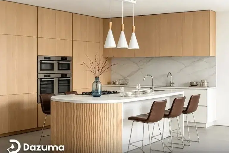 Modern kitchen with light wood cabinetry, double ovens, a marble backsplash, and a curved island with bar stools.