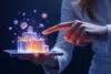 A finger points at glowing, holographic gift boxes appearing to float above a smartphone held by a person.