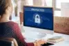 Woman at computer with screen displaying a large padlock icon and the word "PROTECTED".