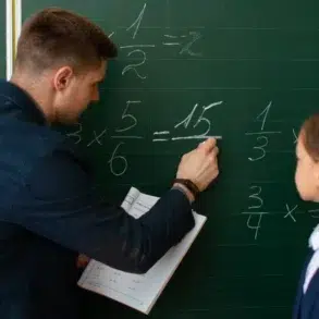 Teacher explains fractions on a chalkboard to a young student.