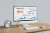 Desktop setup featuring a Reddit analytics dashboard on a computer screen, with charts for community impact, profile growth, and strategic results, alongside a clock and golden arrow.