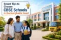 A smiling family stands outside a modern CBSE school in Bannerghatta Road, next to a yellow school bus, with overlay text reading "Smart Tips to Choose CBSE Schools in Bannerghatta Road."