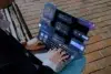 Person using a laptop with floating UI elements displaying financial data and graphs.