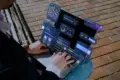 Person using a laptop with floating UI elements displaying financial data and graphs.