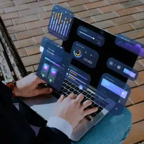 Person using a laptop with floating UI elements displaying financial data and graphs.