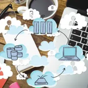 Cloud computing diagram overlays a desk with a laptop, glasses, and coffee, illustrating data storage and connectivity.