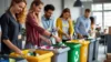 Office workers sort waste into color-coded recycling bins.