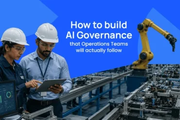 Two manufacturing workers in hard hats review a tablet beside an automated factory line and robotic arm; text reads “How to build AI Governance that Operations Teams will actually follow.”