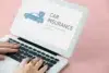 Hands typing on a laptop displaying a blue car with a shield and the words “CAR INSURANCE” on a pink background.