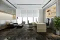 Modern executive office with a black leather seating area, white desk, computer, illuminated display shelves, large windows, and a potted tree.
