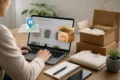 Person shopping online on a laptop beside stacked shipping boxes, a return package, shopping bags, and a home-delivery location graphic.