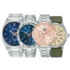 Four ALBA wristwatches are arranged side by side: two blue-dial watches, a rose-gold chronograph, and a cream-dial watch with a green fabric strap.