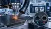 A CNC machine drills a carbon-fiber panel as an inset compares a clean hole with a frayed, delaminated one in a precision factory.