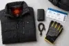 Heated jacket with battery pack and charging cable laid out for work and travel