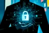 A suited figure holds a glowing padlock amid turquoise circuit-board lines, symbolizing cybersecurity, data protection, and secure digital systems. The mood is futuristic and reassuring.