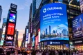 A giant blue Octobank billboard promotes a stronger financial future above bustling Times Square, where crowds and glowing signs create an energetic city scene.