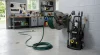 all-mounted steel hose reel with a pressure washer hose partly pulled out.
